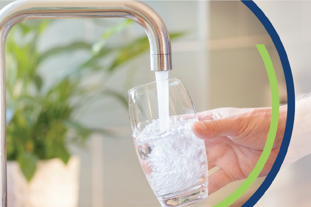 Image of water from kitchen facet filling drinking glass.